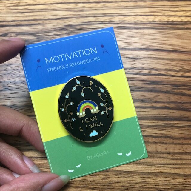 Black enamel pin that reads I can and I will