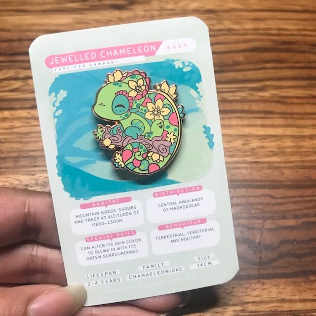 enamel pin of a brightly coloured chameleon