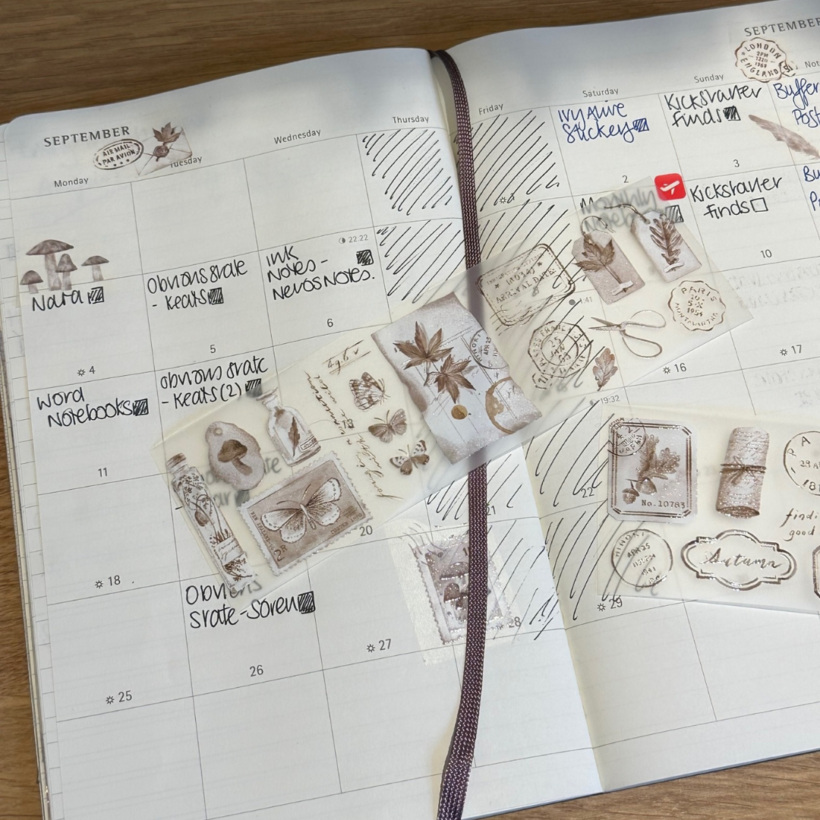 September page of monthly planner decorated with washi tape from the brown roll of "into the fall" washi tape set and with some strips of unstuck washi set out on top
