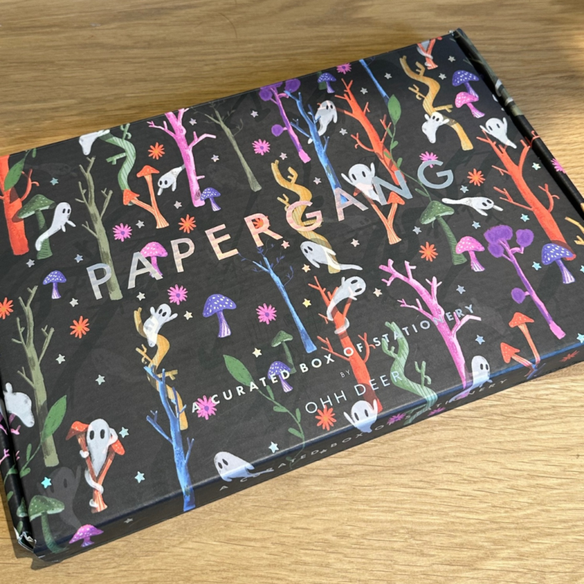 Papergang box design with Ghosts in a colourful forest with toadstools on a black background.
