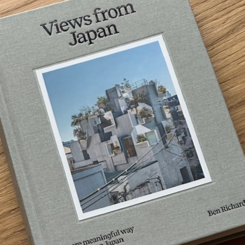 grey hard cover Book titled views from Japan