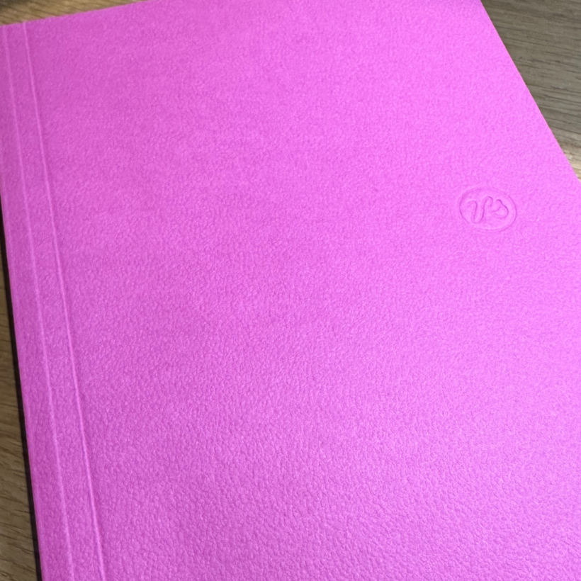 fushia pink notebook with thumb print sized "Papersmiths" monogram to the front.