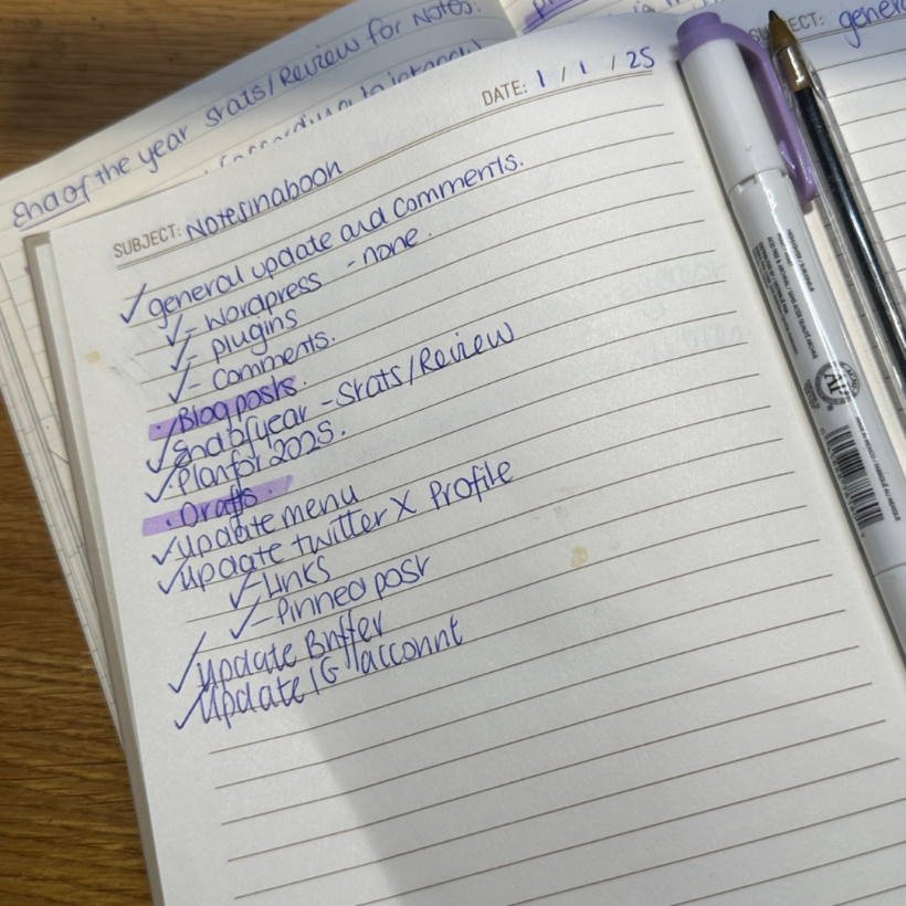 A close-up image of a handwritten to-do list in a notebook with the subject "Notesinsbook" and the date "1/1/25." The list includes tasks like "general update and comments," "blog posts," and "update Twitter X profile," with several items checked off. A purple highlighter and a blue pen rest on the notebook, which is placed on a wooden surface.